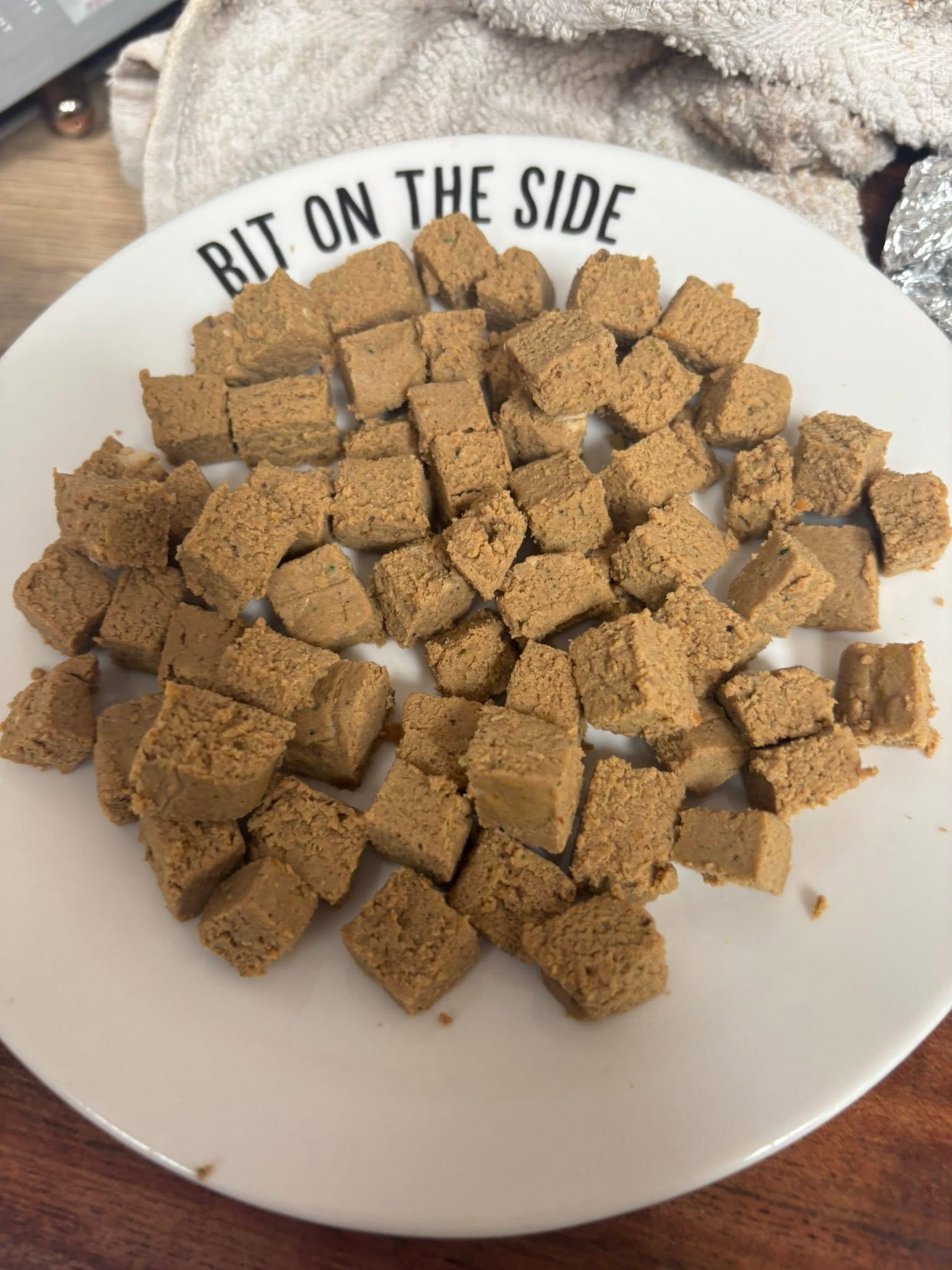 Homemade chub roll cut into small pieces on a plate