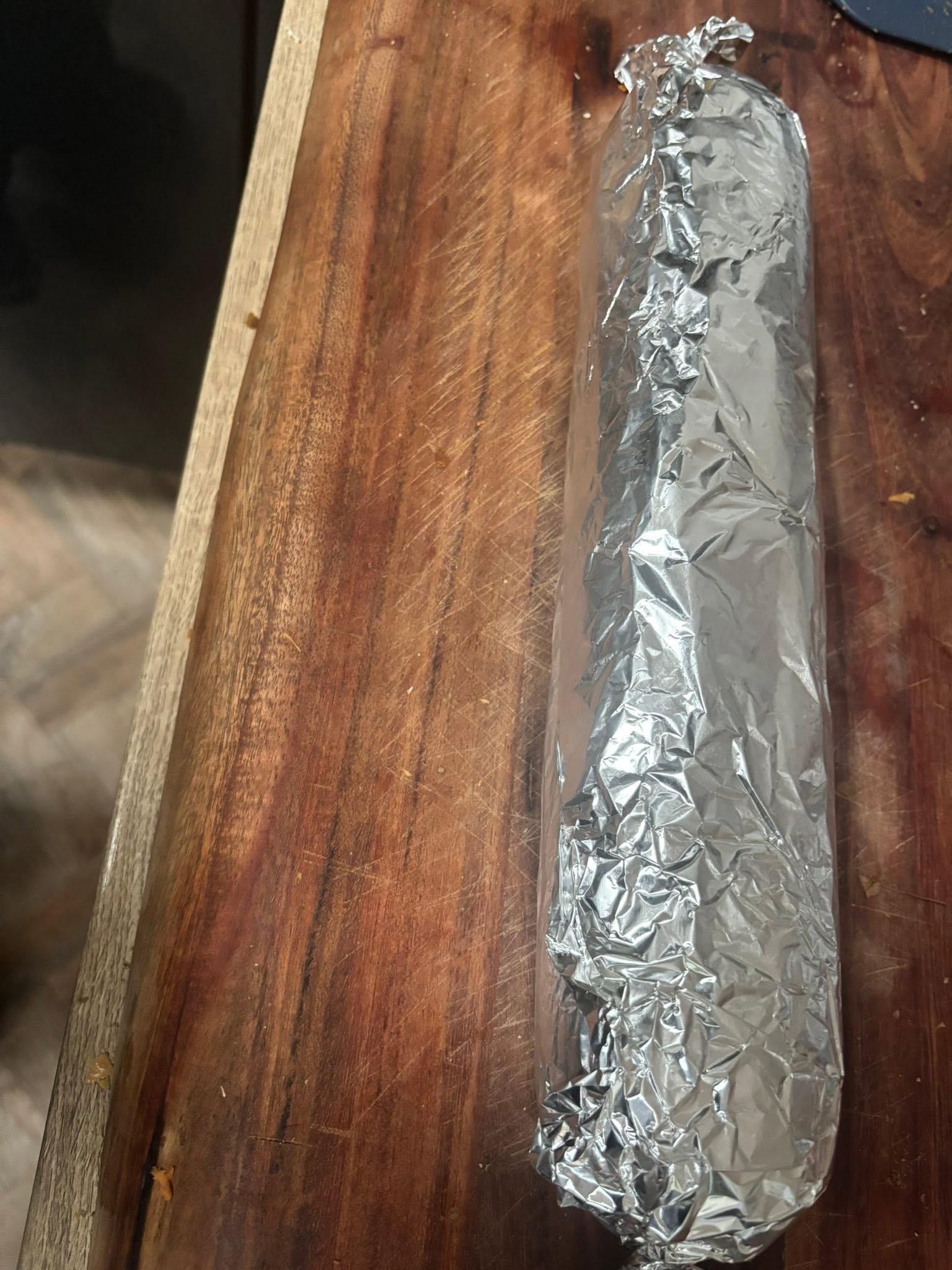 Chub roll enclosed in foil for chilling