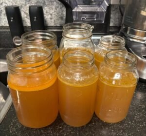 Golden broth in glass jars