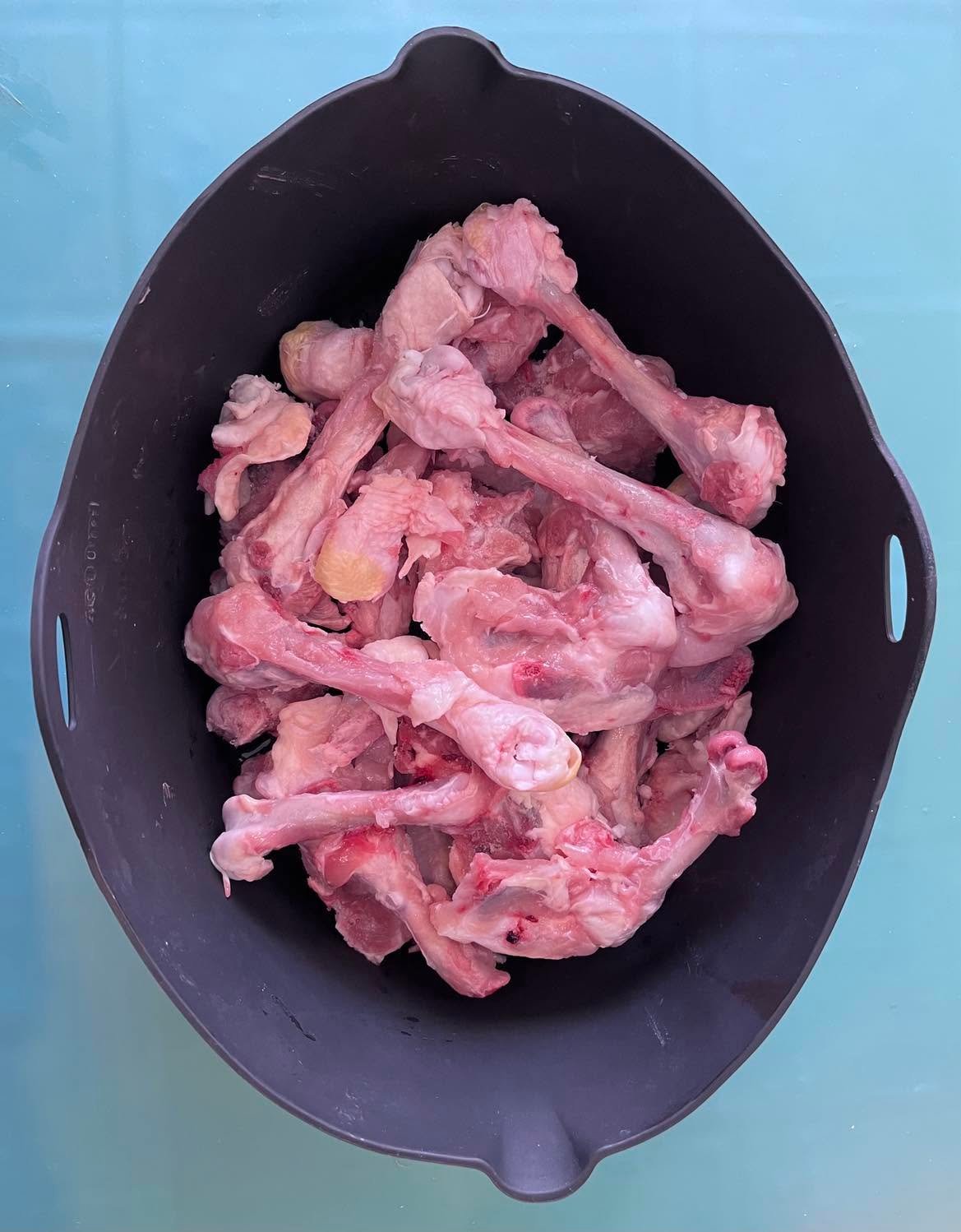 Poultry bones with connective tissue in a silicone liner