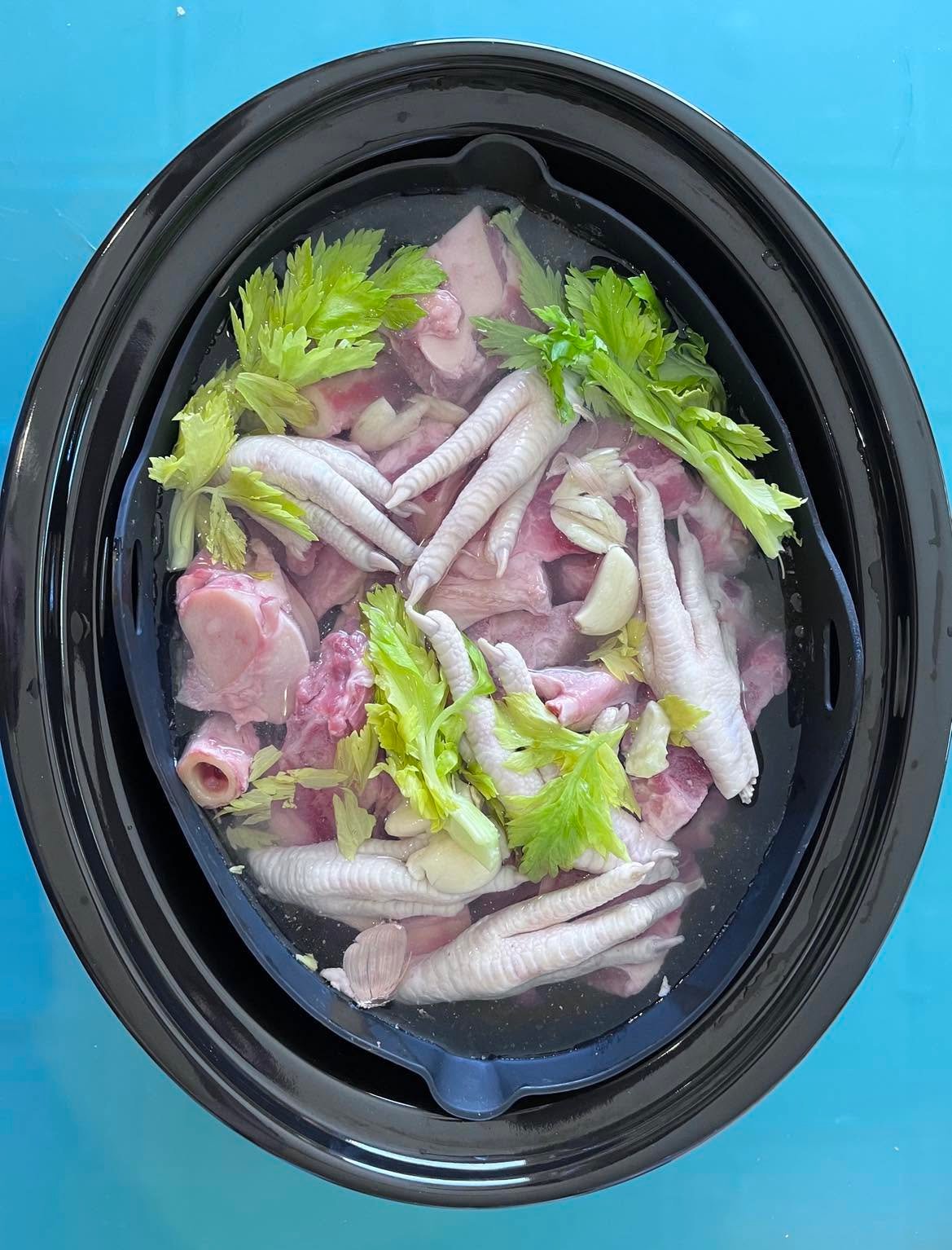 Original broth preparation covered with water; garlic shown must be omitted