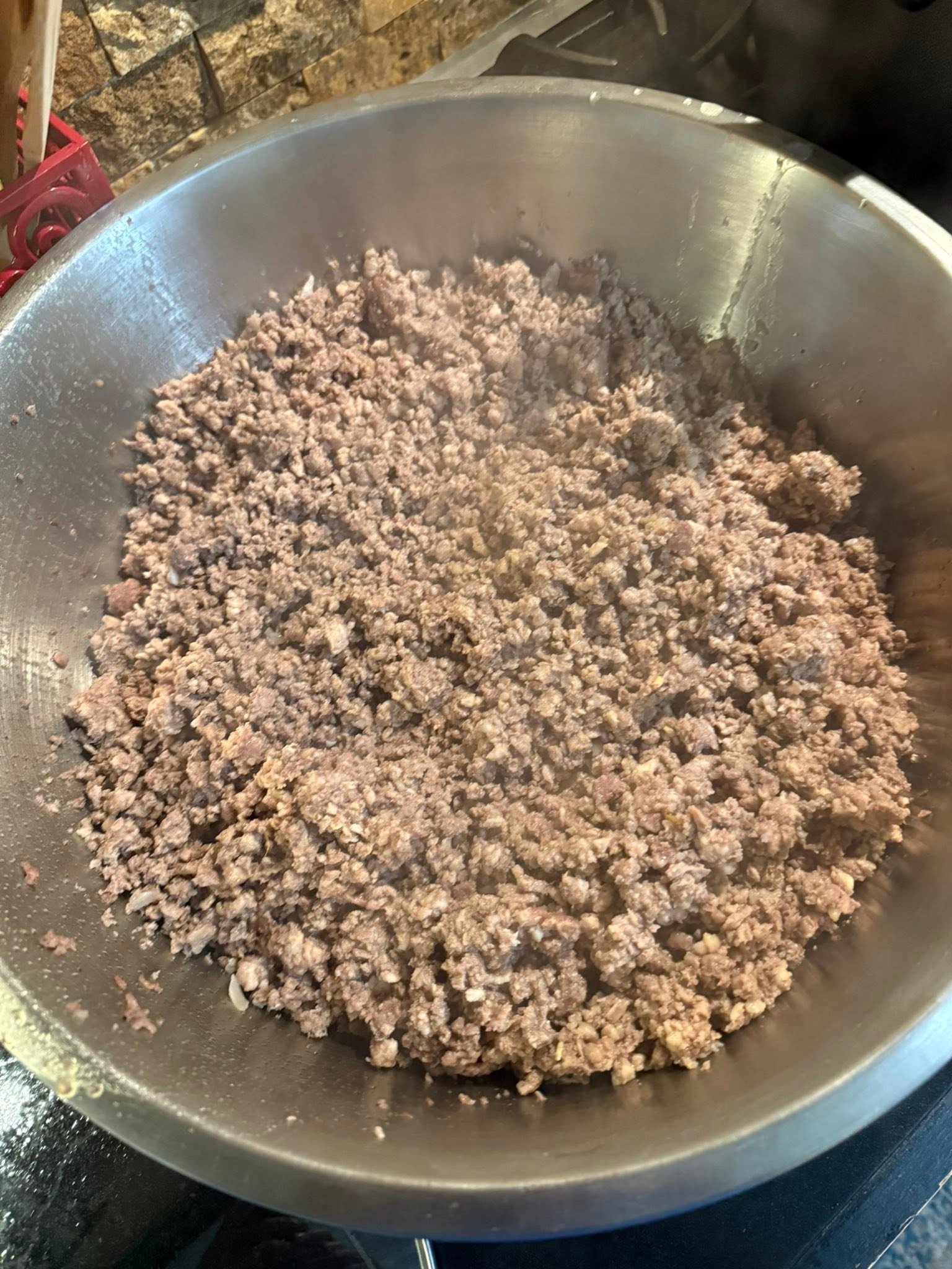 Cooked ground meat in a metal bowl