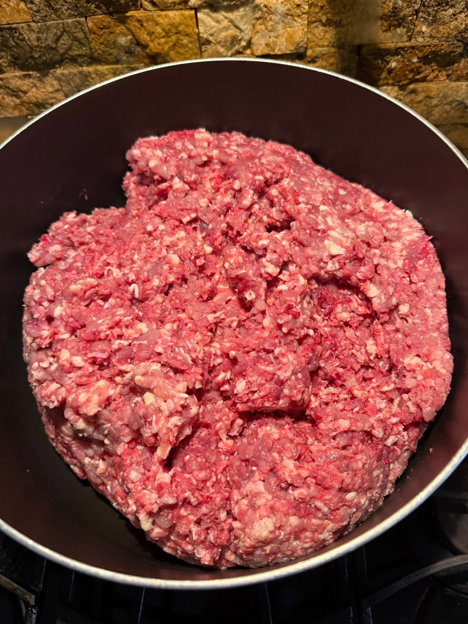 Raw ground meat in a cooking pot