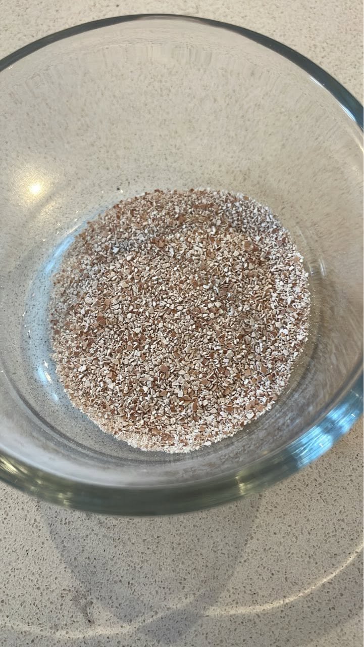 Partly ground eggshells in a glass bowl