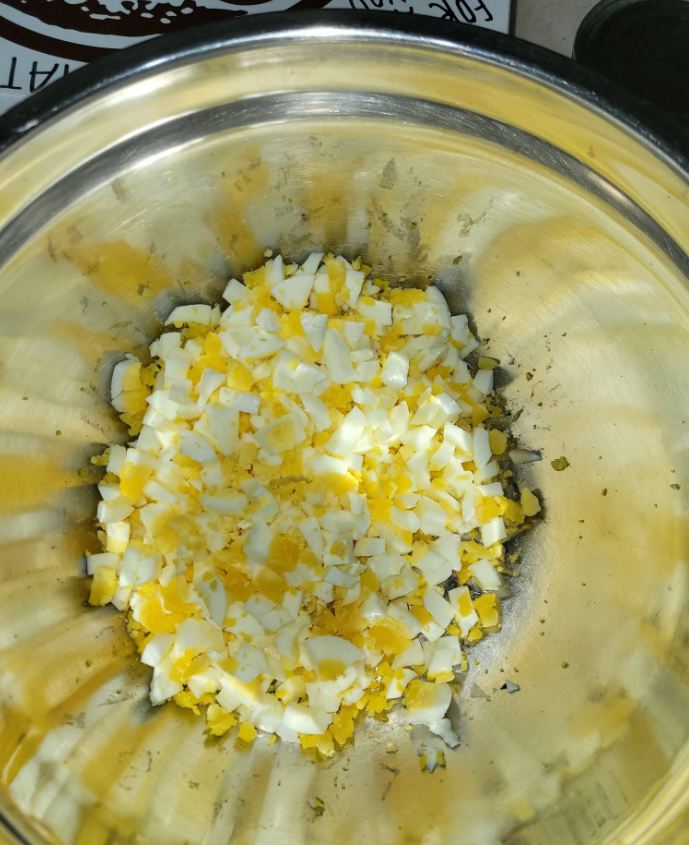 Diced hard-boiled eggs in a metal bowl
