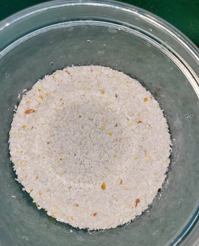Crushed eggshell fragments in a glass bowl