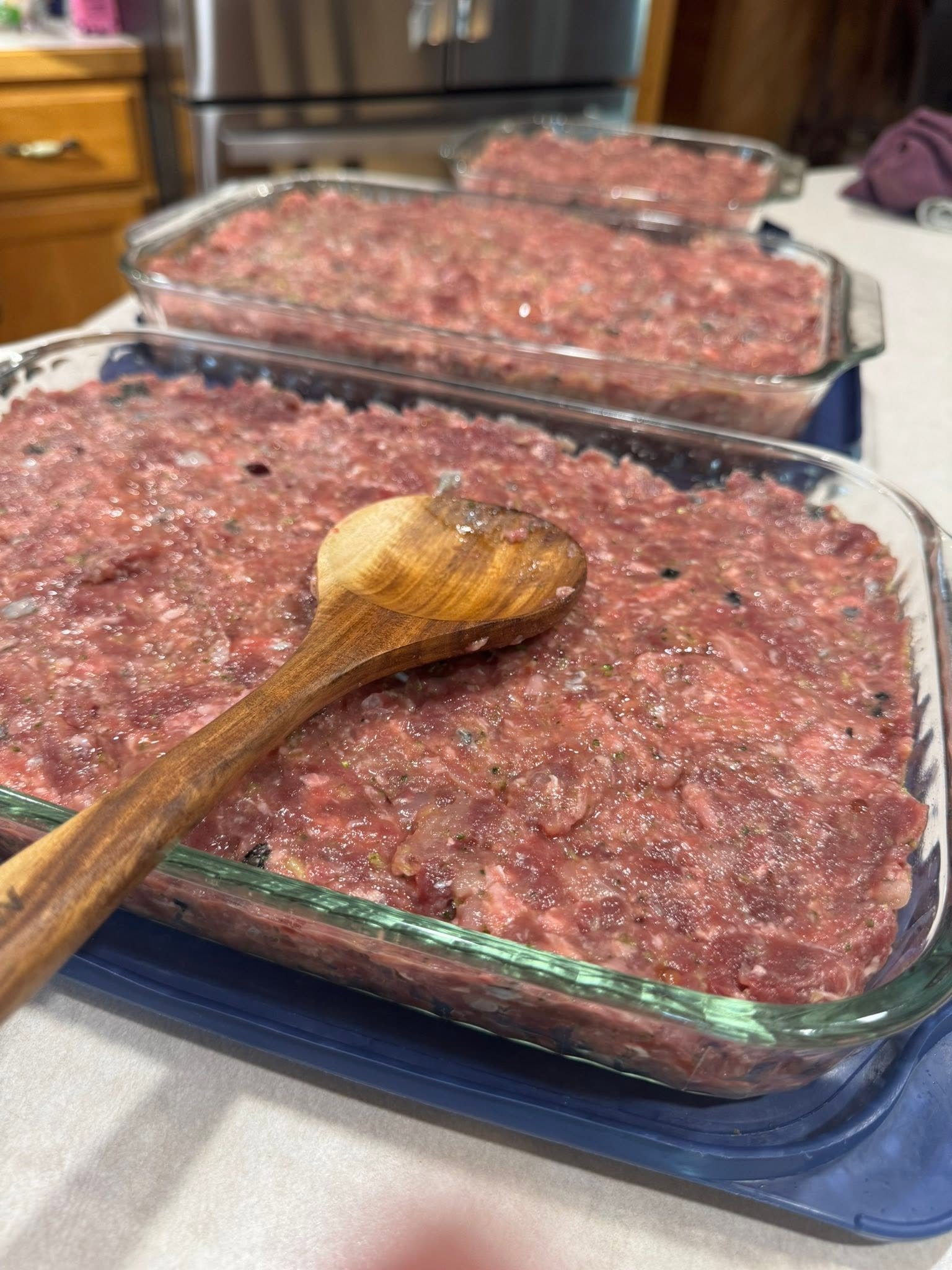 Meatloaf mixture smoothed evenly in glass dishes