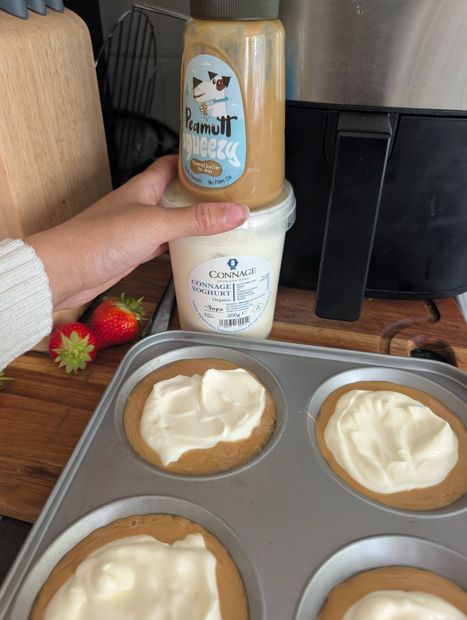Peanut butter and yogurt layers in a tray beside the ingredients