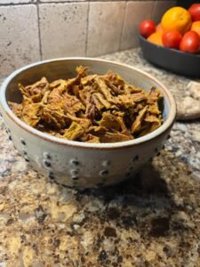 Finished turkey and pumpkin treats broken into pieces in a bowl