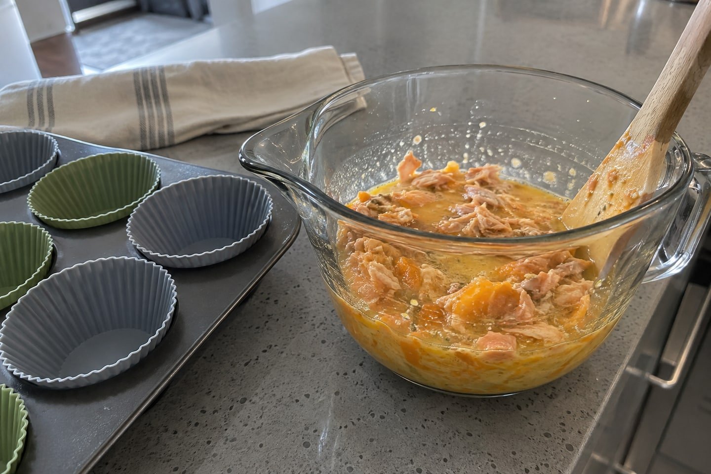 Preparing mini salmon and pumpkin egg muffins for dogs